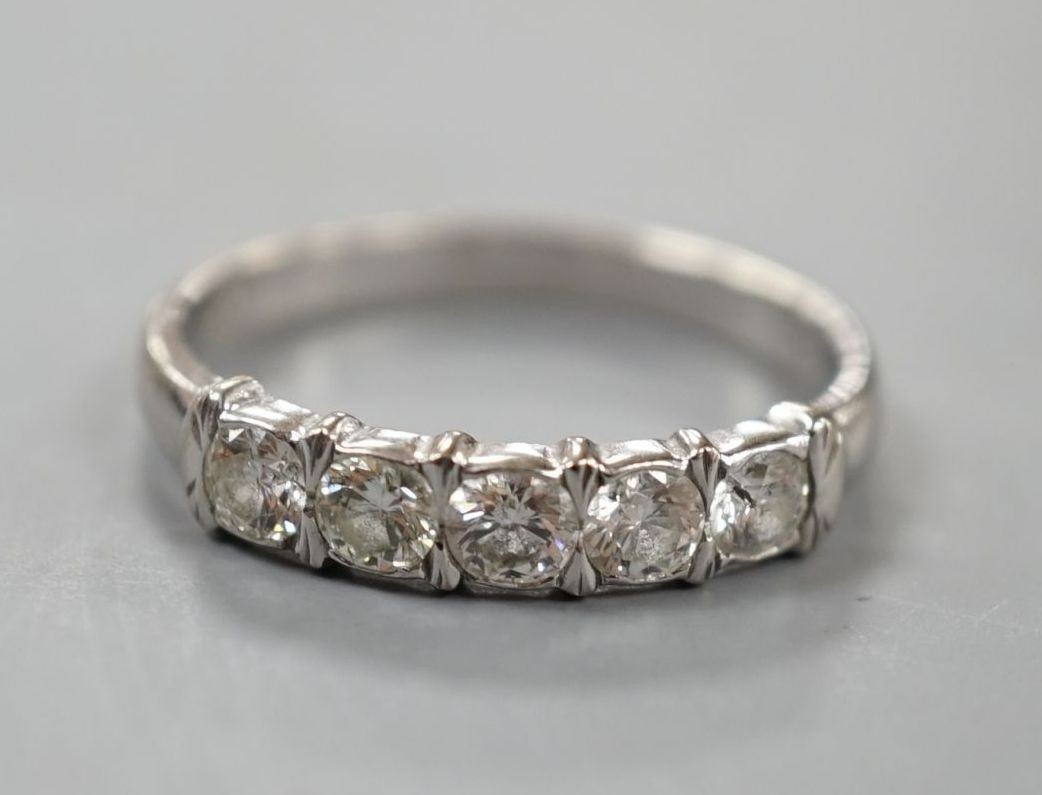 An 18ct white metal and five stone diamond set half hoop ring, size R, gross weight 3.4 grams.